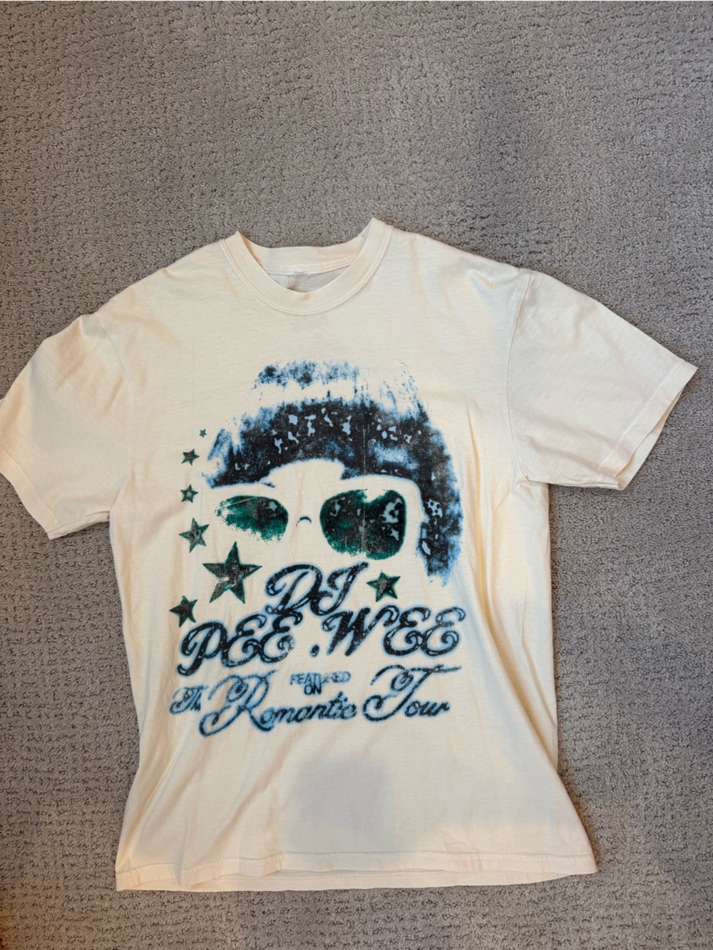 Cream Short Sleeve Graphic Tee with Blue-Green Print. Bruno Mars tour Merch